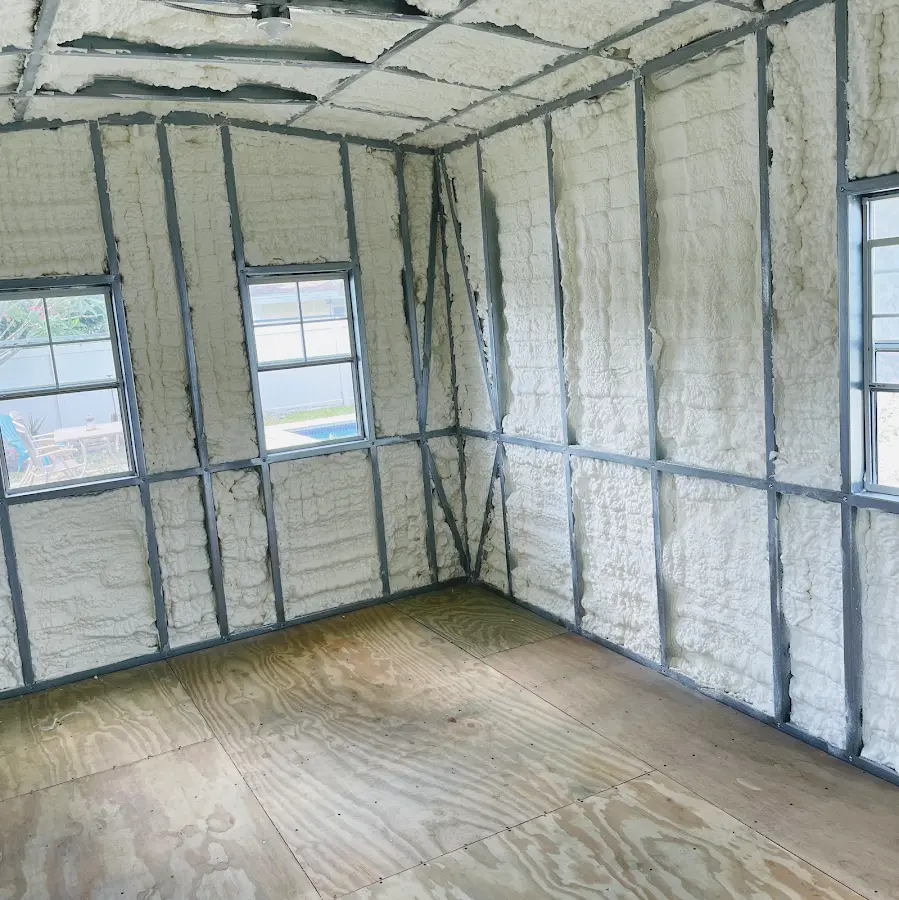 Closed-cell spray foam insulation applied to wall cavities in a residential project in Piqua